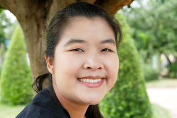 Young Asian Woman smiling in a Public Park