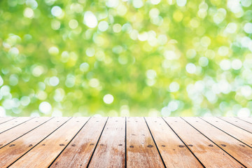 Empty wooden table with party in garden background blurred.