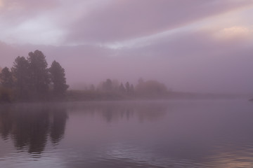 Fototapeta na wymiar Foggy Sunrise Reflection in the Tetons in Autumn