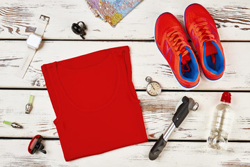Sportsman's clothes and sneakers, smart gadgets and bicycle equipment. Planning a tour and taking essentials. Sport activity, athletics.