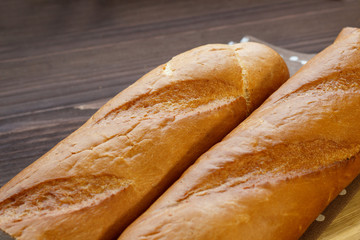 French baguette on the kitchen table. Close-up. Selective focus.