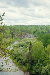 Obraz premium The blue ribbon of the river from the height of the mountains. Wild nature, taiga. Tourism. Far East, Sakhalin Island, Russia.