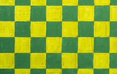 Yellow and green checkerboard pattern on wood background