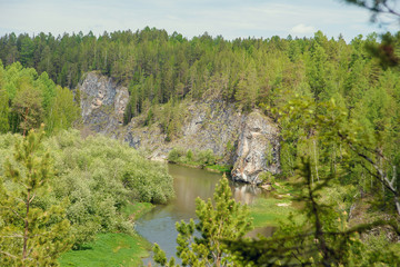 The blue ribbon of the river from the height of the mountains. Wild nature, taiga. Tourism. Far East, Sakhalin Island, Russia.