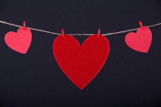 Red paper heart hanging on the clothesline