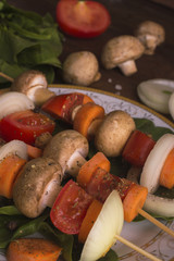 Meat on a skewer rests on a wooden table