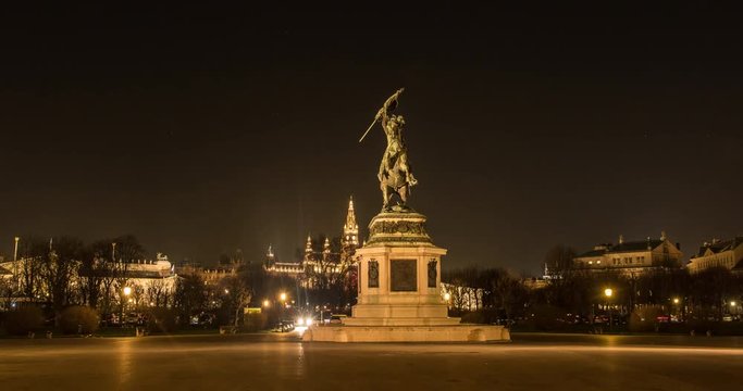 VIENNA, AUSTRIA &ndash; DECEMBER 2015 : Moving timelapse / hyperlapse of Erzhercog Karl statue at night with Rathaus / City Hall and Parliament in view