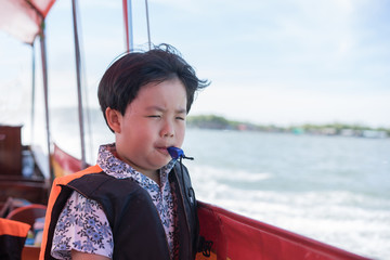 A boy blowing whistles.