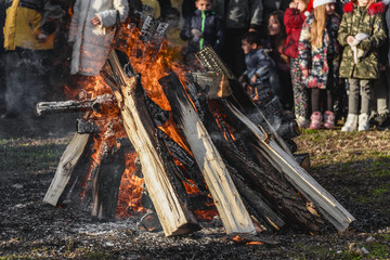 People are firing a large camp fire