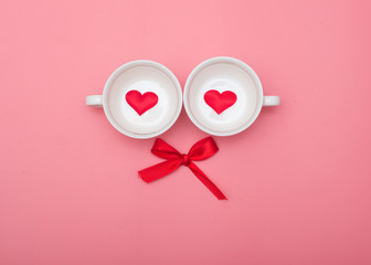 Cup and bow on pink background, valentines day background