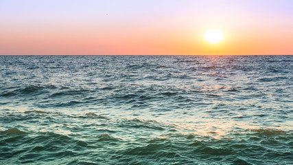 Colorful seascape. Sea waves at sunset