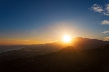 Sunset over the volcano Mount Etna and the gulf of Catania viewed from Taormina, Sicily, Italy, Europe