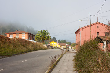 Pink houses along the road in Gallegos, Asturias, Spain
