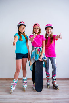 Teens with skateboards and rollerskates