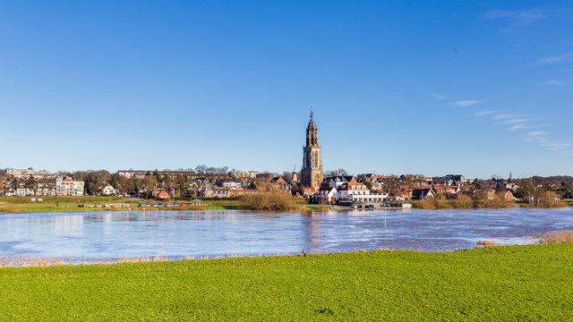 Landscape with a view on the flooded river Rhine and the small town  Rhenen in the Netherlands