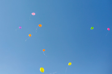Colorful baloons raising to the sky