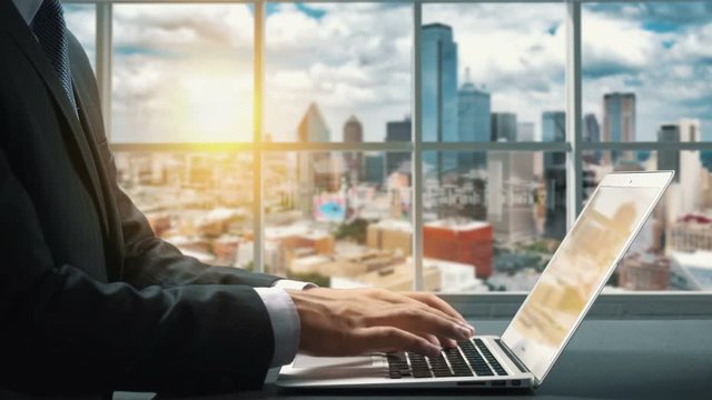 View of Dallas Texas.Close up hand Businessman using laptop