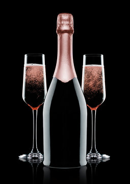 Rose pink champagne glasses and bottle on black