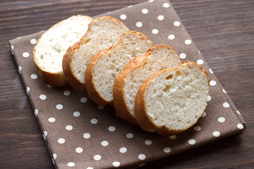 Slices of baguette on a napkin. Close-up. Selective focus.