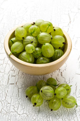 Heap of ripe, fresh harvested green gooseberry fruit in bowl