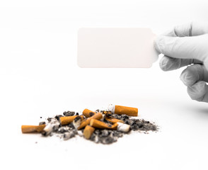 man holding card in front of pile of ashes while wearing medical gloves