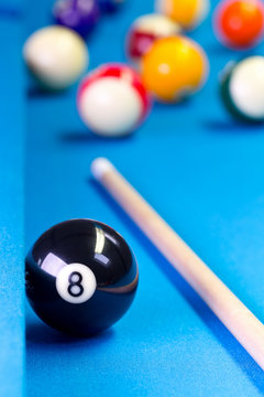 Billiard pool game eight ball with cue on billiard table