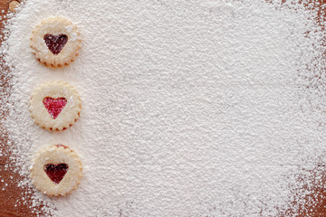 Fototapeta na wymiar Heart Cookies on Powdered Sugar with Copy Space