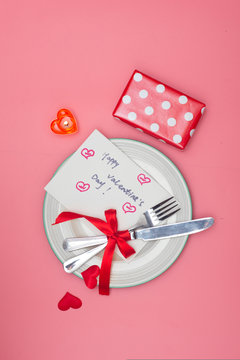 Valentines day table setting with plate On pink background