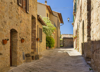Fototapeta na wymiar sunshining day on the street in Tuscany city