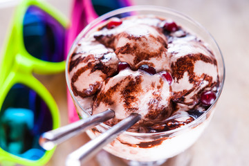 Ice cream sundae, spoons and sun glasses 