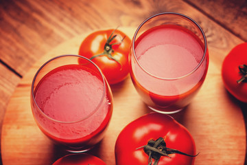 Glasses of fresh tomato juice and tomatoes 