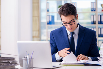 Businessman working with paperwork in the office