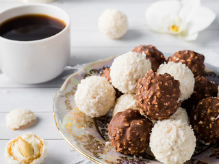Chocolate and Coconut Candies in a Bowl on a Wooden tray Coffee Cup Orchid.