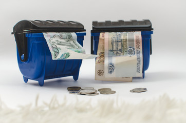 money in the garbage container blue