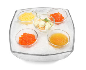 Glass bowl with various caviar on white background