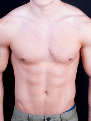bodybuilder man torso posing in studio