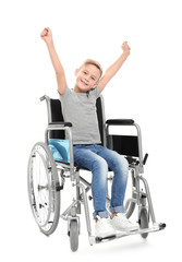 Little boy in wheelchair on white background