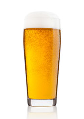 Cold glass of lager ale beer with foam and dew