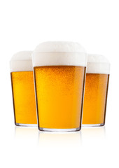 Cold glasses of lager beer with foam and dew