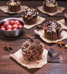 chocolate muffins on a brown wooden background