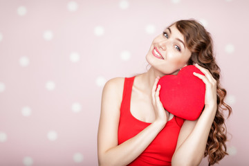 woman with red hearts on pink background.