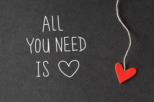 All You Need Is Love message with handmade small paper hearts 