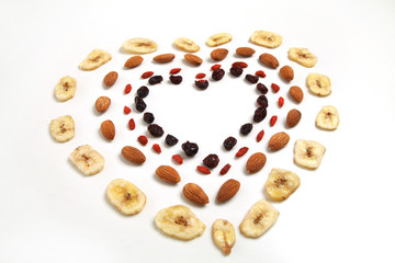 heart shaped mandala of dried fruits and nuts - symbols of jewish holiday Tu Bishvat