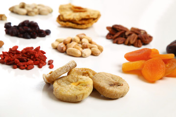 piles of Mixed dried fruits and nuts - symbols of jewish holiday Tu Bishvat