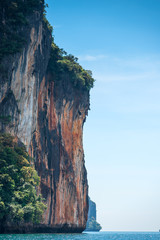 vertical landscape - view of a high steep cliff in the sea in Krabi, Thailand