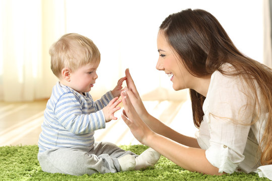 Mother playing with her baby on a carpet