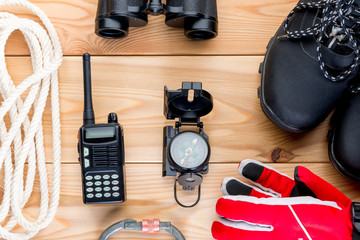 objects for extreme mountain climbing winter view from above on a wooden background