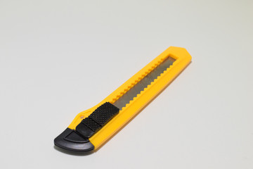 Yellow and black boxcutter tool icon. Household box cutter instrument for general or utility...