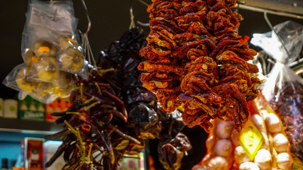 Dried tomatos hanging in Mercado de La Boqueria