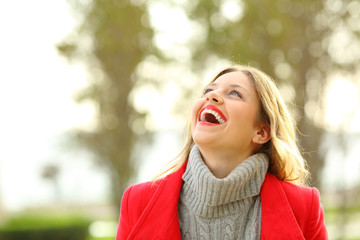 Funny woman looking above in winter